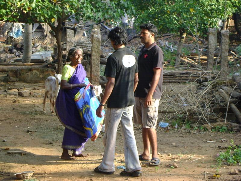 Photographer: | Boobalan (in the middle) distributing the painted tarpaulins