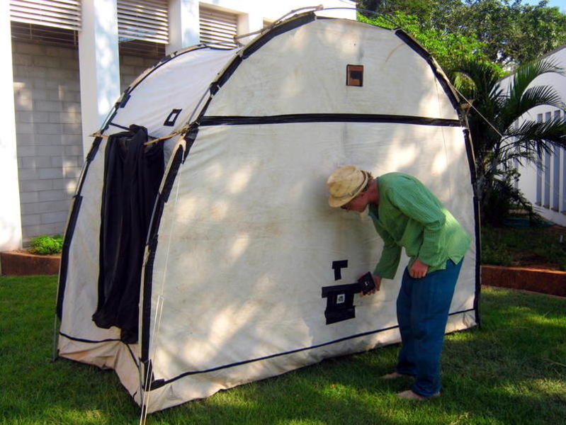 Photographer:Maria | Gotz Rogge are fixing some filter on the stenopaic hole in the tent transformed in Camera Obscura