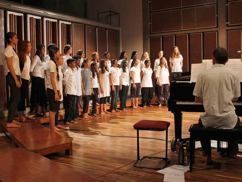 Photographer:Heidrun Holzfeind | On piano Matt accompanying the Auroville Youth Choir