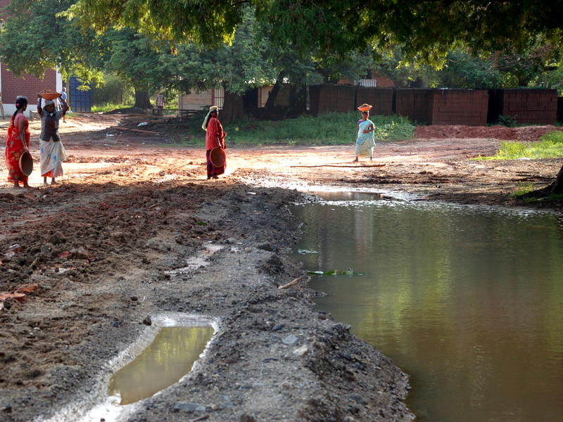 Photographer:Frida | Women are reconstructing a damaged road opposite New Creation