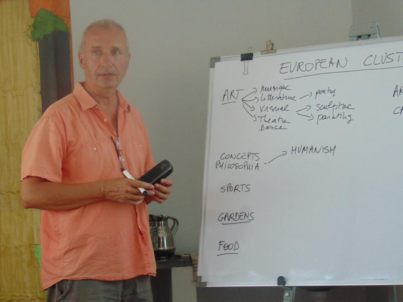 Photographer:Gino | Denis writing on a board the points made by participants