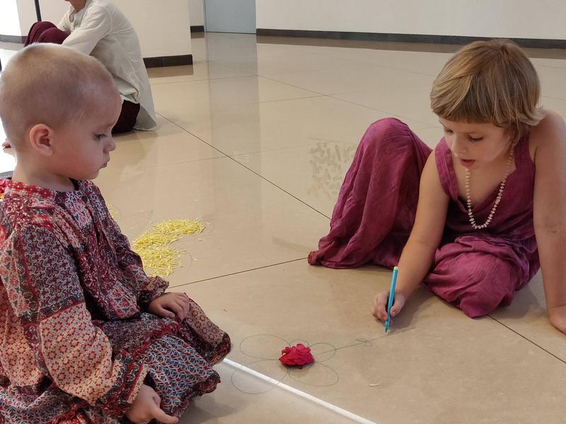 Photographer:Akshay | Two young children drawing on the floor as part of an activity