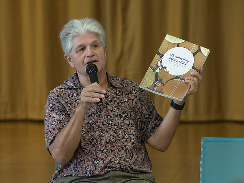 Photographer:Marco Saroldi | Mr Carel holding up the Auroville today 12 year compilation 2006 - 20018
